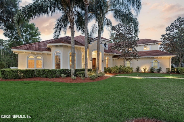 2579 Woodgrove Rd, Fleming Island, FL 32003 - mediterranean / spanish house with a tile roof, stucco siding, and a front yard
