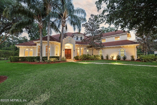 2579 Woodgrove Rd, Fleming Island, FL 32003 - mediterranean / spanish home with stucco siding, a tile roof, and a front yard
