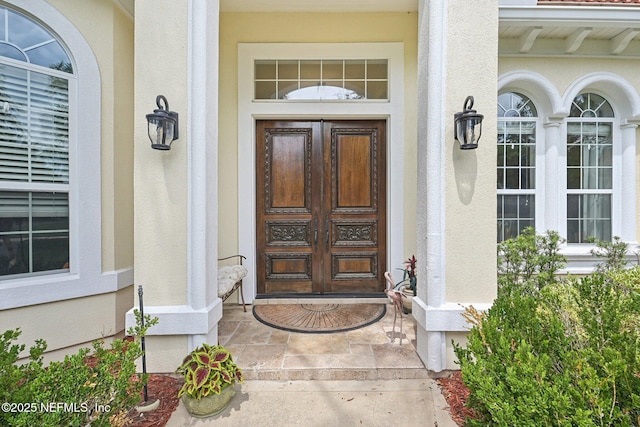2579 Woodgrove Rd, Fleming Island, FL 32003 - doorway to property with french doors, stucco siding, and covered porch