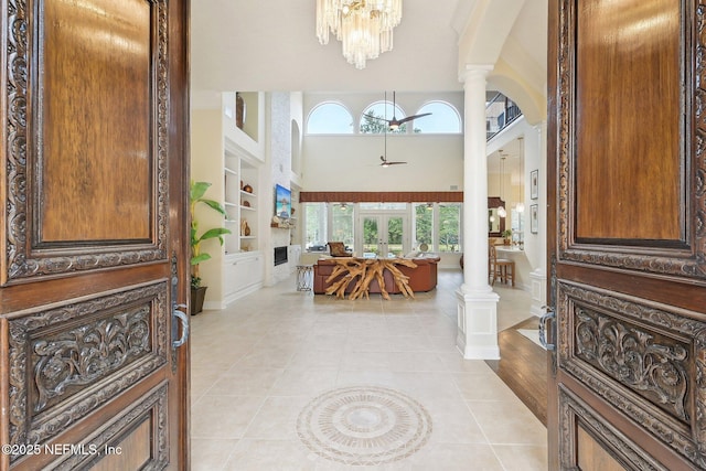 2579 Woodgrove Rd, Fleming Island, FL 32003 - entryway featuring decorative columns, ceiling fan, light tile patterned floors, french doors, and a chandelier