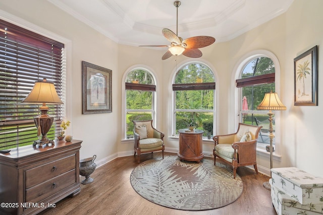 2579 Woodgrove Rd, Fleming Island, FL 32003 - living area with a tray ceiling, crown molding, ceiling fan, wood finished floors, and baseboards
