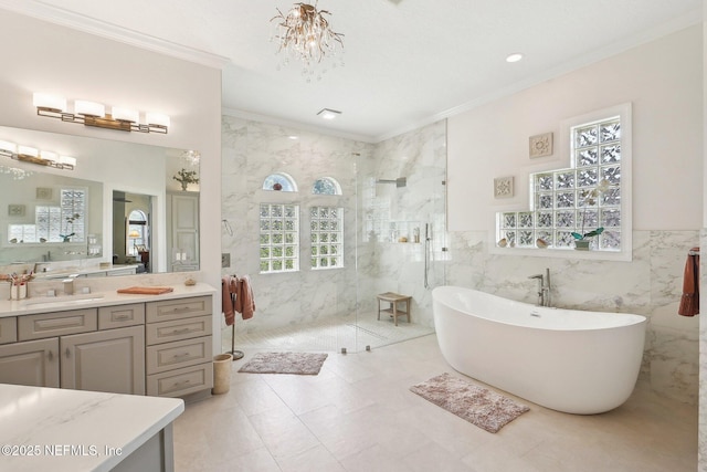 2579 Woodgrove Rd, Fleming Island, FL 32003 - bathroom with tile walls, ornamental molding, a marble finish shower, healthy amount of natural light, and a freestanding bath