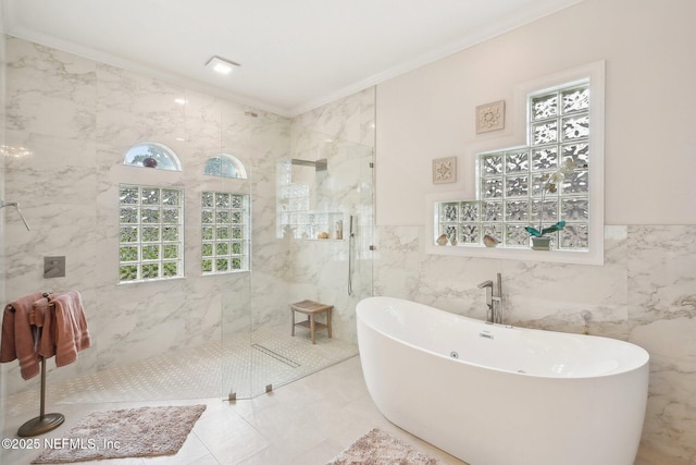 2579 Woodgrove Rd, Fleming Island, FL 32003 - full bathroom featuring tile walls, a freestanding tub, a marble finish shower, ornamental molding, and marble finish flooring
