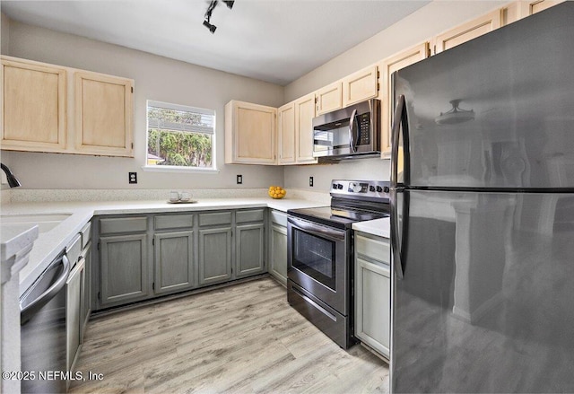 1800 The Greens Way Unit 406, Jacksonville Beach, FL 32250 - kitchen with appliances with stainless steel finishes, light countertops, light wood-style floors, and light brown cabinets
