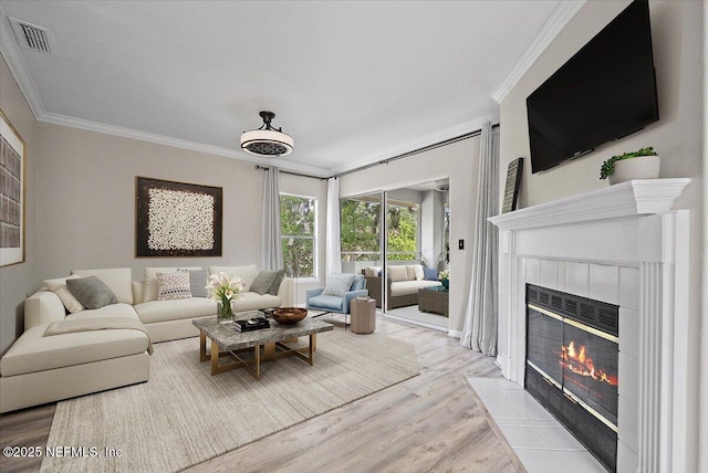 1800 The Greens Way Unit 406, Jacksonville Beach, FL 32250 - living area featuring ornamental molding, wood finished floors, and a tile fireplace