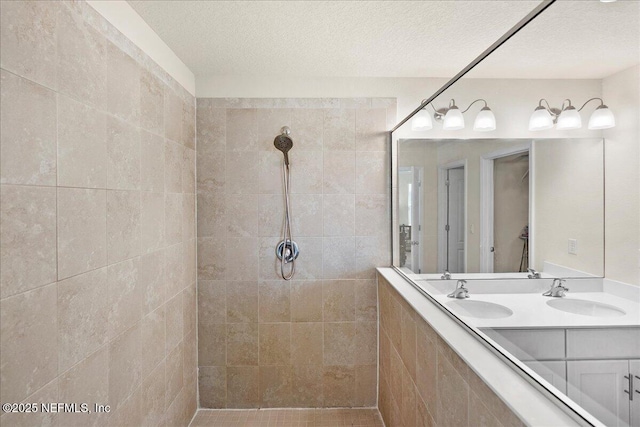 2629 Cold Stream Ln, Green Cove Springs, FL 32043 - full bathroom with tiled shower, double vanity, and a textured ceiling