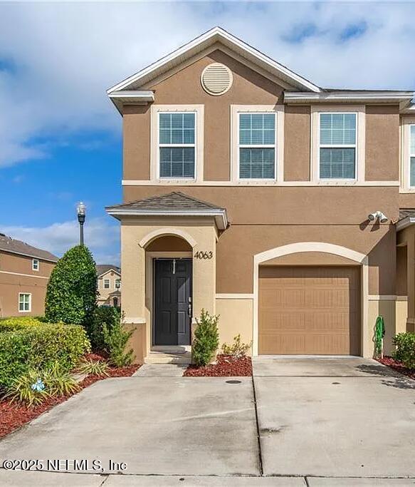 4063 70th Ter N, Pinellas Park, FL 33781 - view of property with a garage, stucco siding, and driveway