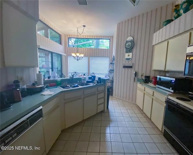 2642 Bent Hickory Cir, Longwood, FL 32779 - kitchen featuring dishwashing machine, stainless steel microwave, electric range oven, wallpapered walls, and a chandelier