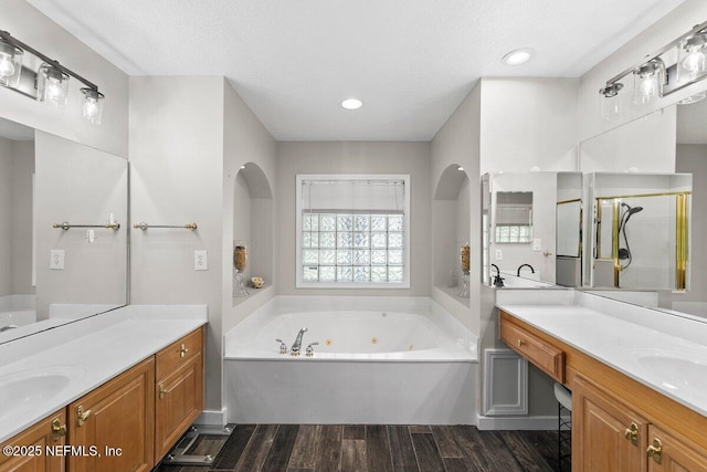 1759 Rising Oaks Dr, Jacksonville, FL 32223 - bathroom with wood finished floors, a jetted tub, and two vanities