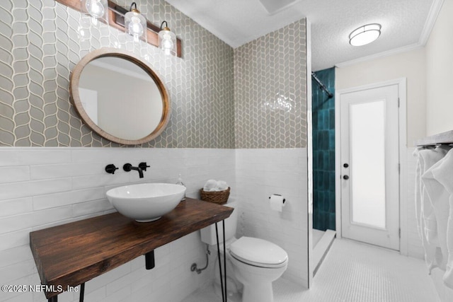1759 Rising Oaks Dr, Jacksonville, FL 32223 - bathroom with tile walls, a tile shower, a sink, toilet, and tile patterned flooring