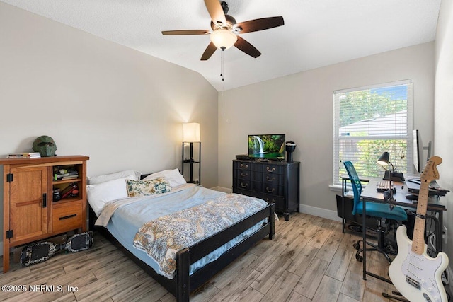 1759 Rising Oaks Dr, Jacksonville, FL 32223 - bedroom with light wood-style flooring, vaulted ceiling, a desk, baseboards, and a ceiling fan