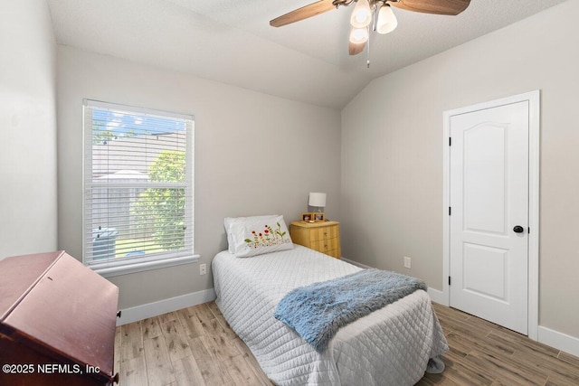 1759 Rising Oaks Dr, Jacksonville, FL 32223 - bedroom featuring multiple windows, light wood-style floors, baseboards, and vaulted ceiling