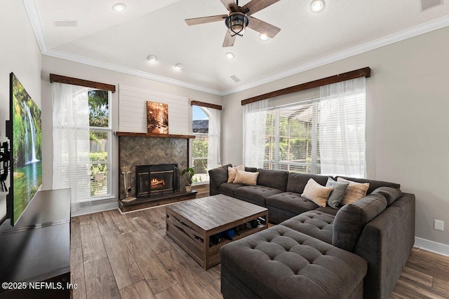 1759 Rising Oaks Dr, Jacksonville, FL 32223 - living area featuring ceiling fan, plenty of natural light, wood finished floors, crown molding, and a tiled fireplace