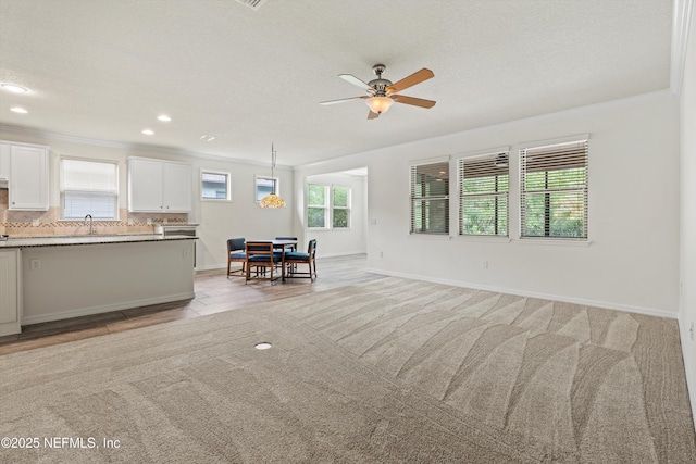 109 Sweet Pine Trl, Ponte Vedra, FL 32081 - living room with crown molding, a ceiling fan, healthy amount of natural light, light colored carpet, and baseboards