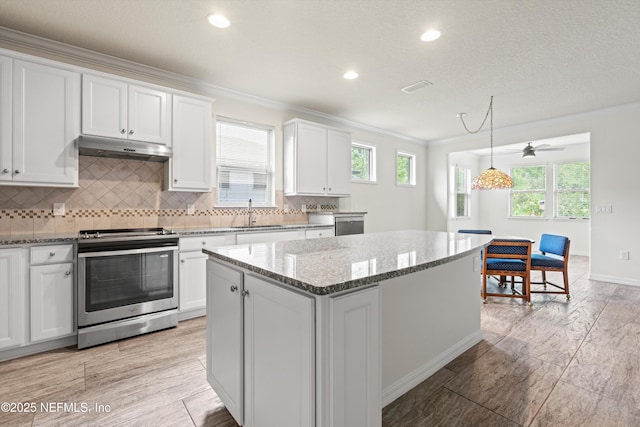 109 Sweet Pine Trl, Ponte Vedra, FL 32081 - kitchen featuring stainless steel range with electric cooktop, under cabinet range hood, a sink, white cabinetry, and a kitchen island