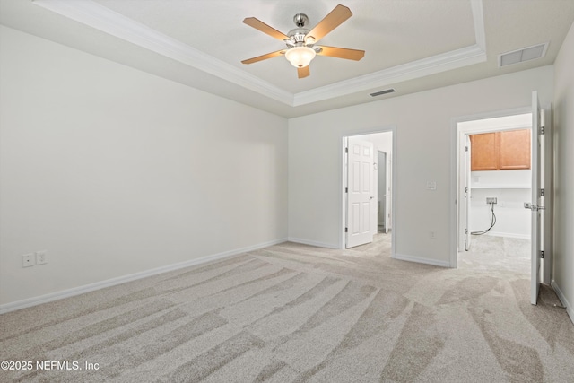 109 Sweet Pine Trl, Ponte Vedra, FL 32081 - unfurnished bedroom featuring a raised ceiling, crown molding, light colored carpet, a walk in closet, and baseboards