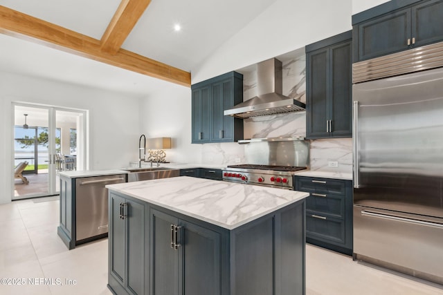 95544 Wilder Blvd, Fernandina Beach, FL 32034 - kitchen with high end appliances, wall chimney exhaust hood, a sink, a peninsula, and backsplash