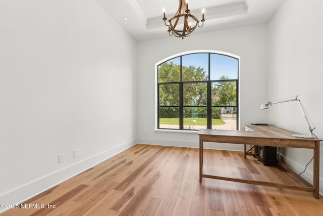 95544 Wilder Blvd, Fernandina Beach, FL 32034 - unfurnished office featuring plenty of natural light, a chandelier, a raised ceiling, and light wood finished floors