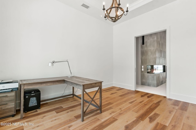 95544 Wilder Blvd, Fernandina Beach, FL 32034 - home office with a chandelier, light wood-style floors, and baseboards