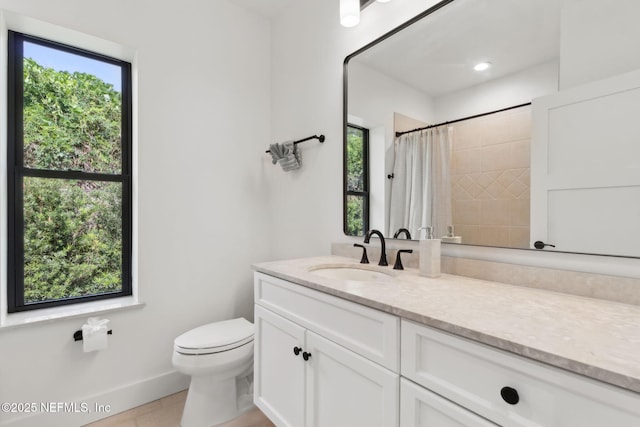 95544 Wilder Blvd, Fernandina Beach, FL 32034 - bathroom featuring vanity, toilet, a shower with shower curtain, baseboards, and tile patterned floors
