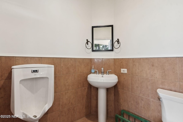 95544 Wilder Blvd, Fernandina Beach, FL 32034 - half bathroom featuring toilet, wainscoting, and a sink