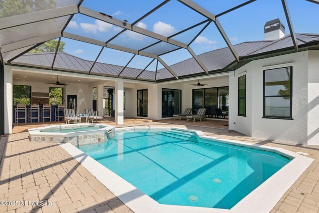 95544 Wilder Blvd, Fernandina Beach, FL 32034 - view of swimming pool featuring a ceiling fan, a patio area, a pool with connected hot tub, and a lanai