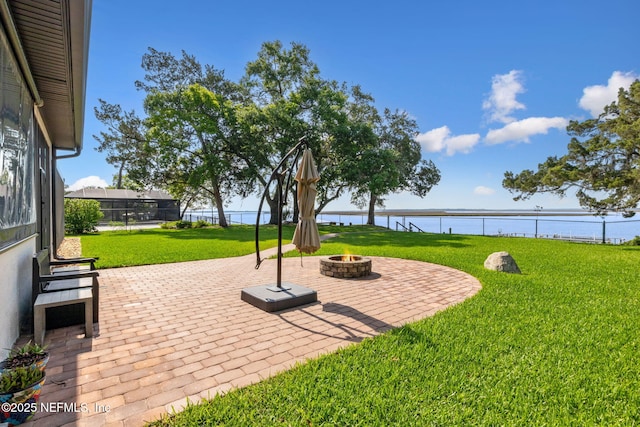 95544 Wilder Blvd, Fernandina Beach, FL 32034 - view of patio / terrace with an outdoor fire pit and a water view