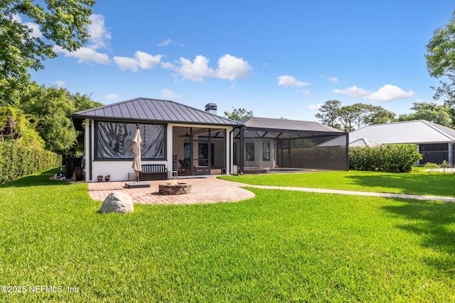 95544 Wilder Blvd, Fernandina Beach, FL 32034 - rear view of property featuring an outdoor fire pit, a patio, a lawn, and metal roof