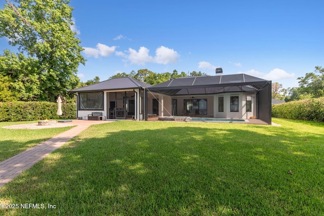95544 Wilder Blvd, Fernandina Beach, FL 32034 - back of house with a lawn, metal roof, a sunroom, and a patio