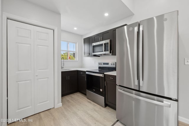 2010 N Main St, Jacksonville, FL 32206 - kitchen with stainless steel appliances, light wood finished floors, a sink, light countertops, and recessed lighting