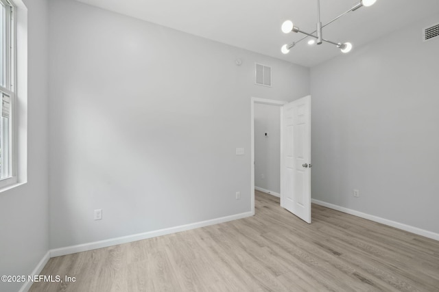 2010 N Main St, Jacksonville, FL 32206 - empty room featuring wood finished floors, a chandelier, and baseboards