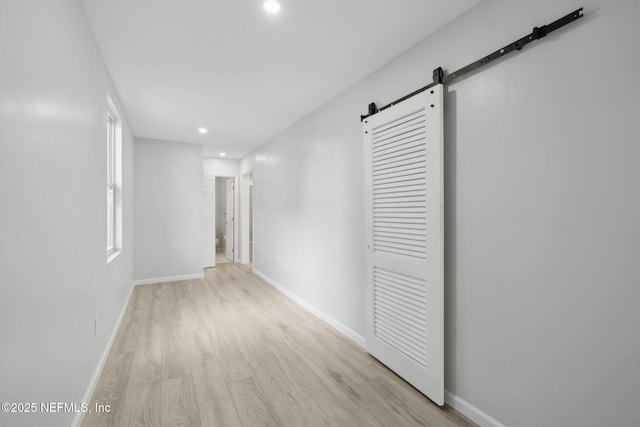 2010 N Main St, Jacksonville, FL 32206 - hall with a barn door, light wood-style floors, recessed lighting, and baseboards