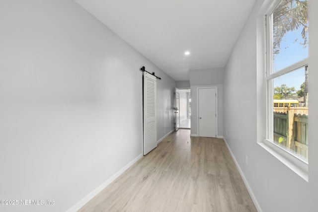 2010 N Main St, Jacksonville, FL 32206 - hallway featuring a barn door, light wood-style flooring, baseboards, and recessed lighting