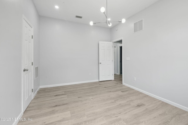 2010 N Main St, Jacksonville, FL 32206 - unfurnished room featuring a chandelier, light wood-style flooring, and baseboards