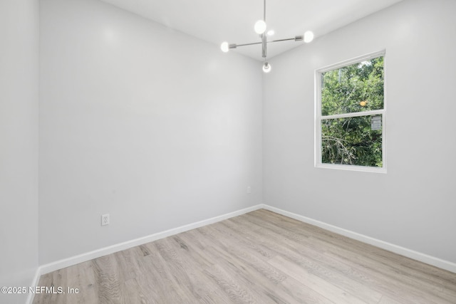 2010 N Main St, Jacksonville, FL 32206 - unfurnished room featuring wood finished floors, a chandelier, and baseboards