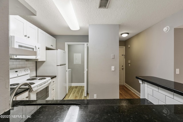 7701 Timberlin Park Blvd Unit 331, Jacksonville, FL 32256 - kitchen with white appliances, light wood-style floors, white cabinets, backsplash, and a textured ceiling