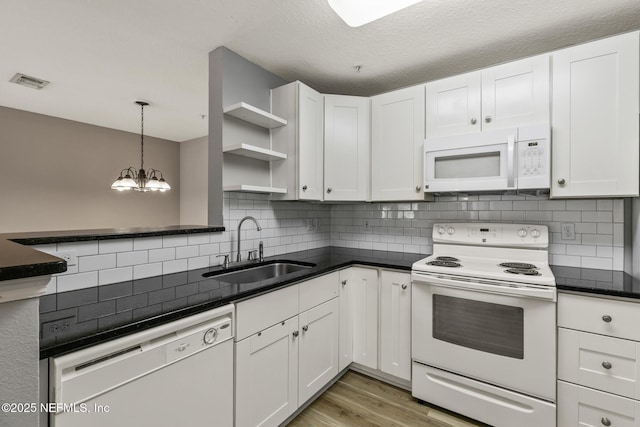 7701 Timberlin Park Blvd Unit 331, Jacksonville, FL 32256 - kitchen with white appliances, a sink, white cabinets, and light wood-style flooring