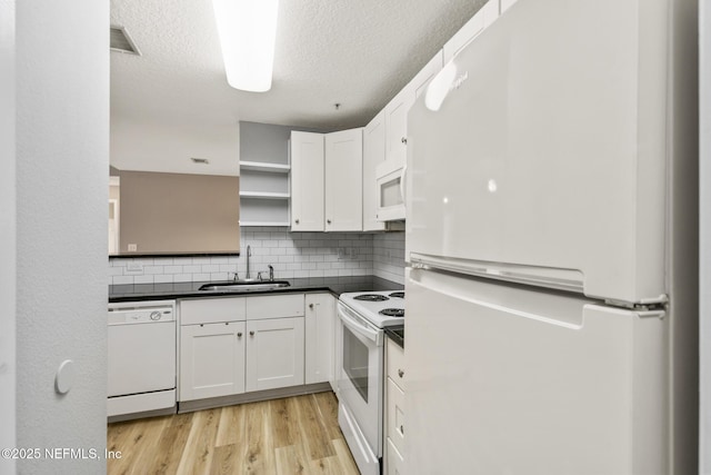 7701 Timberlin Park Blvd Unit 331, Jacksonville, FL 32256 - kitchen with white appliances, a sink, open shelves, dark countertops, and white cabinets