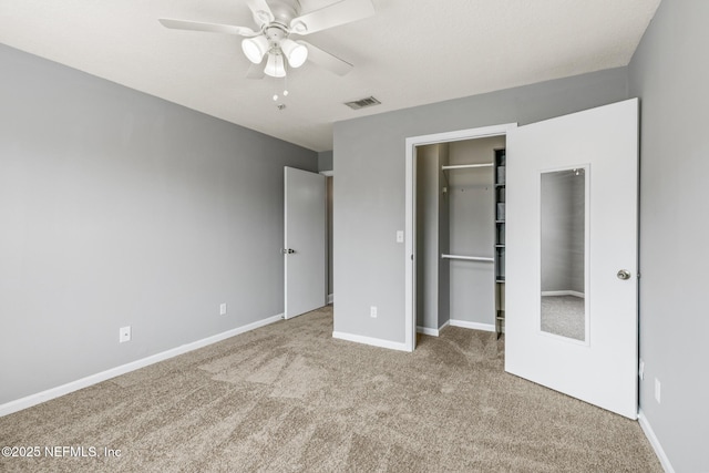 7701 Timberlin Park Blvd Unit 331, Jacksonville, FL 32256 - unfurnished bedroom featuring carpet, a spacious closet, a closet, baseboards, and a ceiling fan