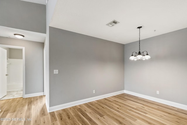 7701 Timberlin Park Blvd Unit 331, Jacksonville, FL 32256 - spare room featuring light wood-style flooring, baseboards, and a chandelier