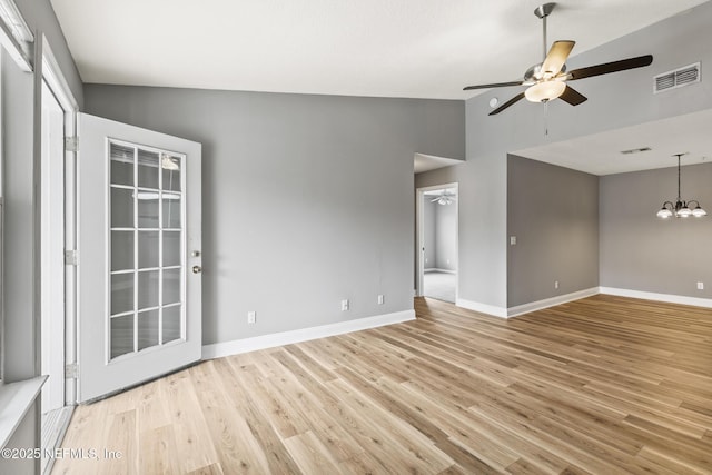 7701 Timberlin Park Blvd Unit 331, Jacksonville, FL 32256 - empty room with a ceiling fan, vaulted ceiling, light wood-type flooring, baseboards, and a chandelier