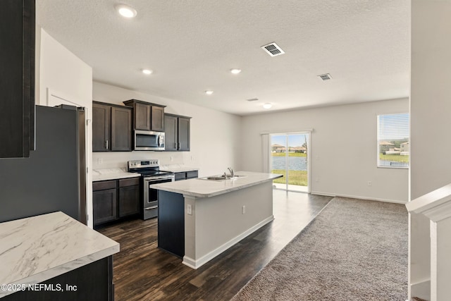 3238 Little Fawn Ln, Green Cove Springs, FL 32137 - kitchen with appliances with stainless steel finishes, a sink, dark wood-type flooring, a kitchen island with sink, and recessed lighting