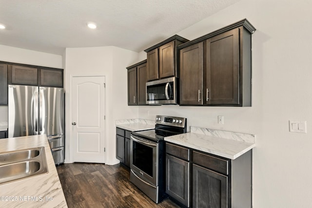 3238 Little Fawn Ln, Green Cove Springs, FL 32137 - kitchen featuring appliances with stainless steel finishes, light countertops, dark brown cabinetry, dark wood finished floors, and recessed lighting