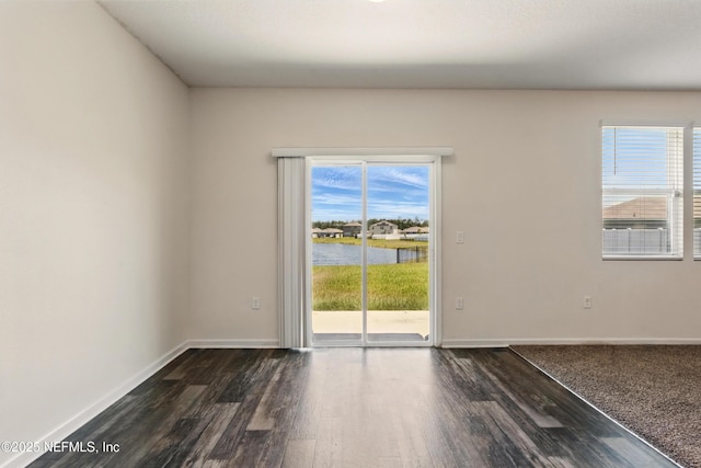 3238 Little Fawn Ln, Green Cove Springs, FL 32137 - spare room with a water view, dark wood finished floors, and baseboards
