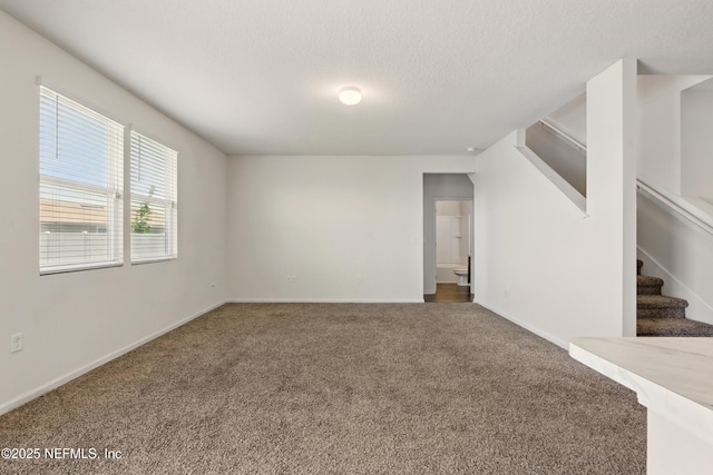 3238 Little Fawn Ln, Green Cove Springs, FL 32137 - empty room with carpet, a textured ceiling, stairway, and baseboards