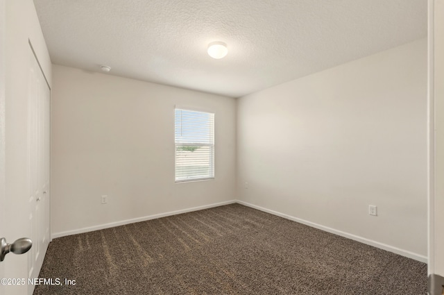 3238 Little Fawn Ln, Green Cove Springs, FL 32137 - empty room featuring dark carpet, baseboards, and a textured ceiling