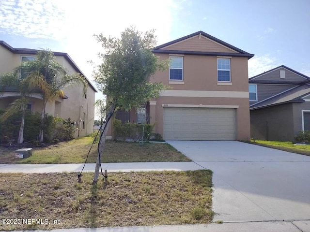 3180 Oyster Cover St, Wimauma, FL 33598 - view of front facade with stucco siding, concrete driveway, and a garage