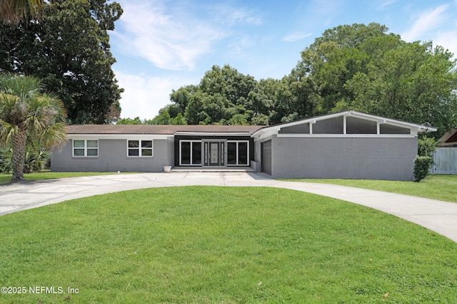 7930 Bellemeade Blvd, Jacksonville, FL 32211 - view of front of property featuring concrete driveway, a front yard, and an attached garage