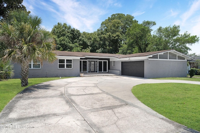 7930 Bellemeade Blvd, Jacksonville, FL 32211 - view of front of property with a front lawn, a garage, and driveway