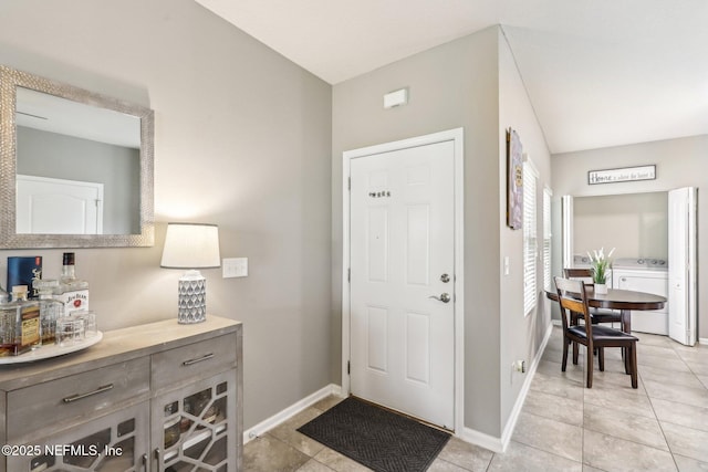 236 Servia Dr, Saint Johns, FL 32259 - entryway with washer / dryer, light tile patterned flooring, and baseboards